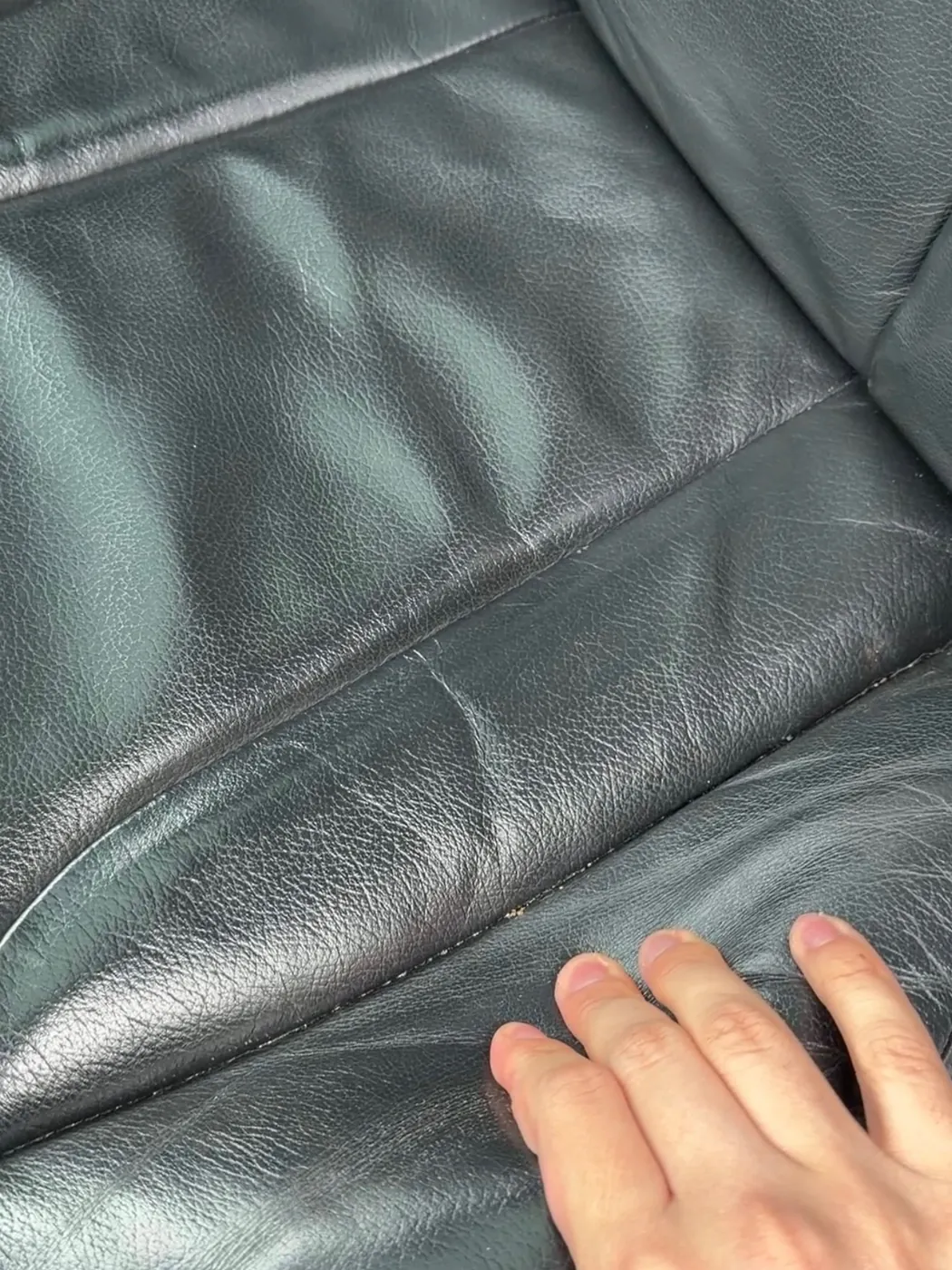 Leather seat before conditioning — dry, cracked, creased