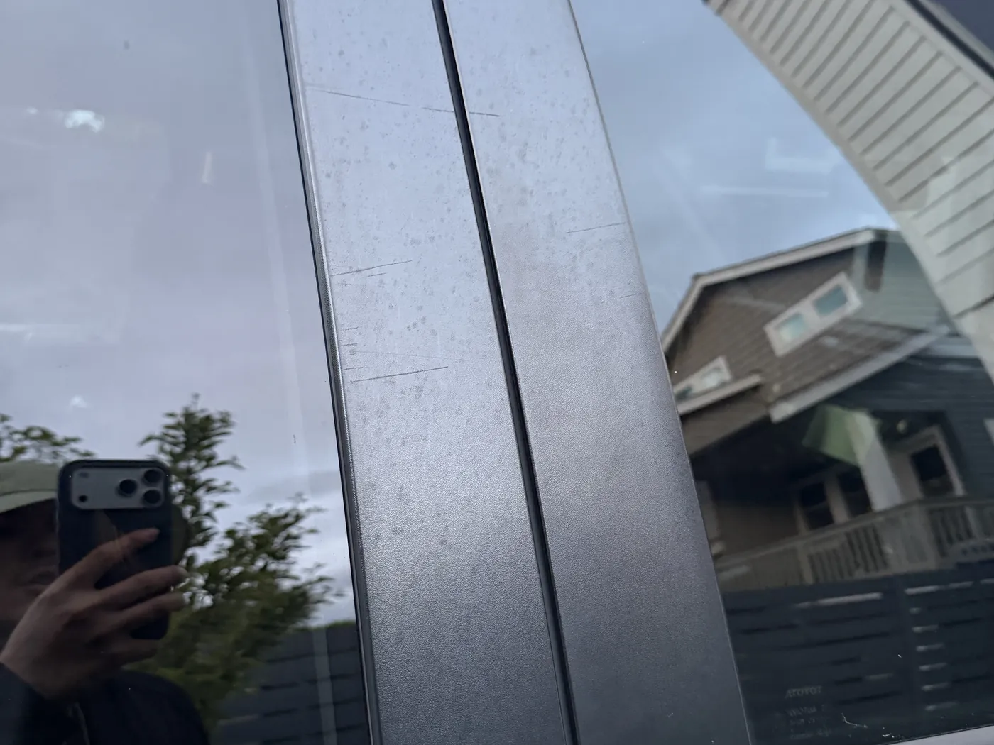 B-pillar trim before restoration — oxidized, hazy, gray