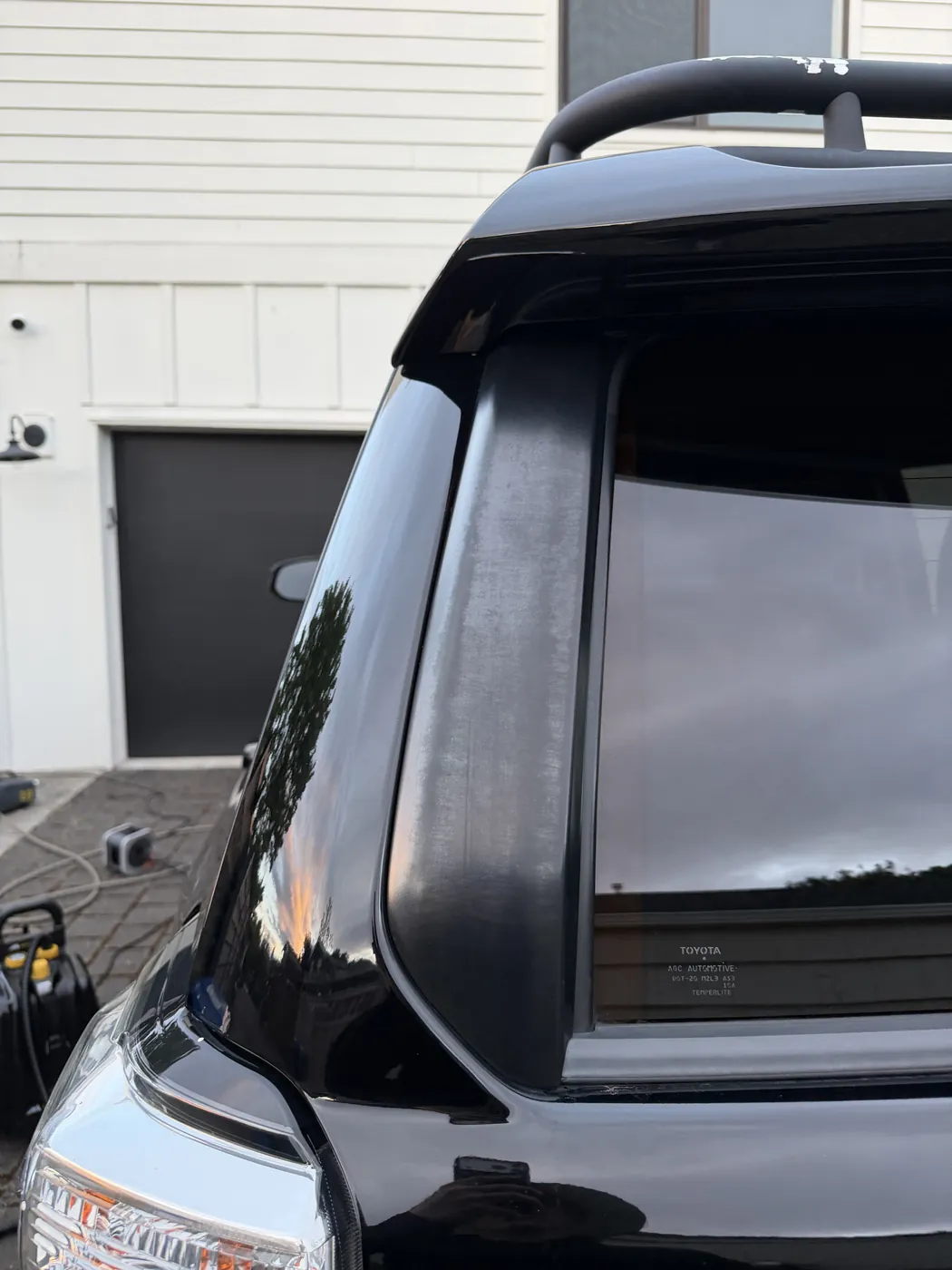 Rear tailgate trim before dressing — dusty, sun-faded